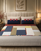 Navy blue and beige patchwork bed ensemble with embroidered floral pillow covers