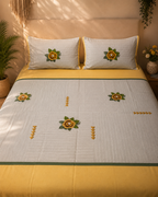 Mustard yellow and light grey bedsheet set with embroidered flowers and matching pillow covers
