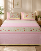 Light pink striped bedsheet set with bird and floral designs and matching pillow covers