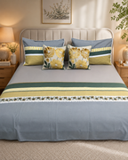 Slate blue bedsheet set with mustard and olive borders and matching yellow floral cushion covers