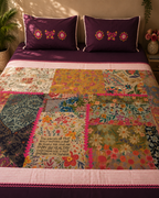 Plum bedsheet set with colourful floral patchwork panels and matching embroidered pillow covers