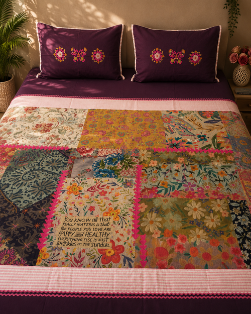 Plum bedsheet set with colourful floral patchwork panels and matching embroidered pillow covers