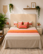 Ivory bedsheet set with coral, peach and gold borders and coordinated decorative pillow covers by Rituxe Living