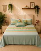 Sage green luxury bedsheet with floral patterned panel, gold border and coordinated decorative pillow covers by Rituxe Living