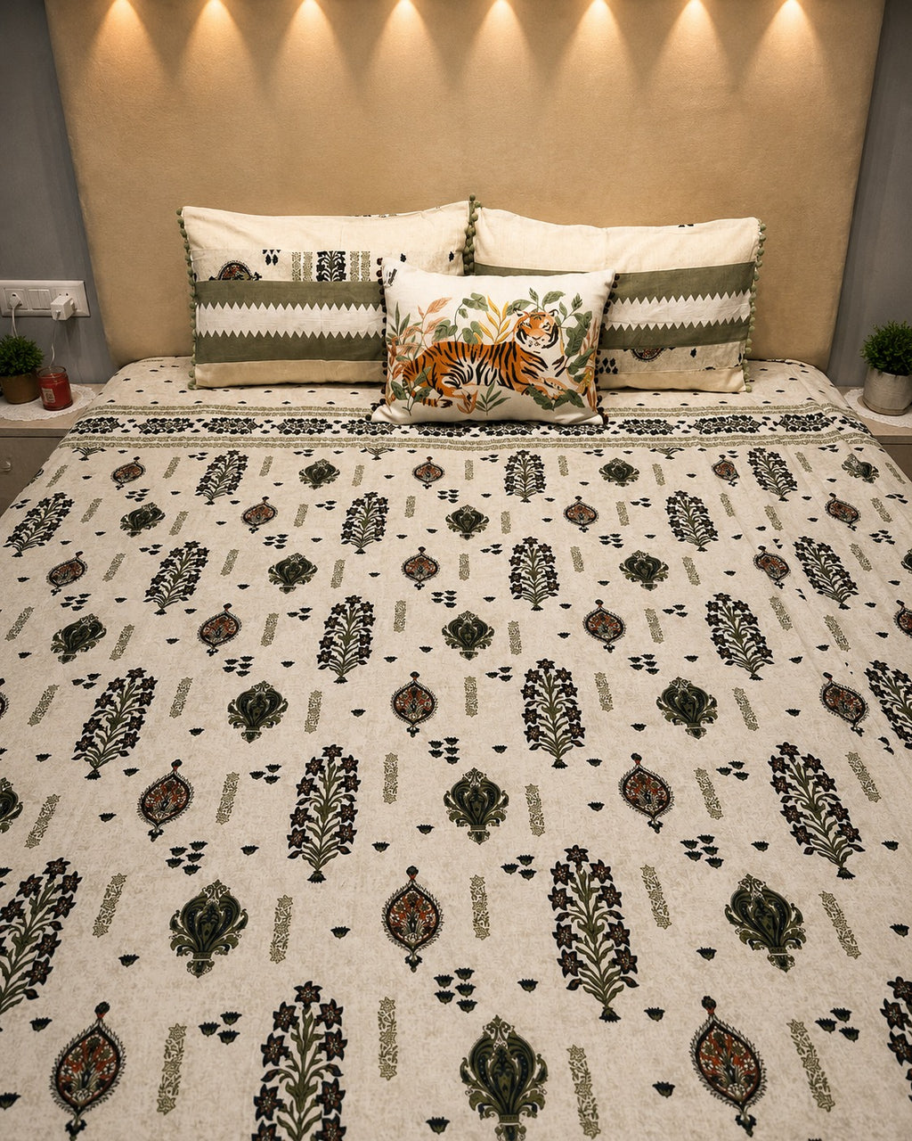 Ivory botanical bedsheet set with olive green motifs and coordinated pom-pom pillow covers by Rituxe Living