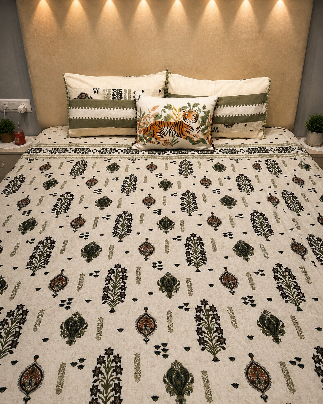 Ivory botanical bedsheet set with olive green motifs and coordinated pom-pom pillow covers by Rituxe Living