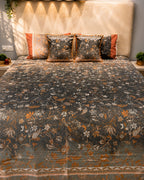 Charcoal grey floral bedsheet set with rust-orange accents and pom-pom decorative pillow covers by Rituxe Living