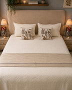 Ivory quilted bedsheet set with beige accent runner and woodland deer decorative cushions